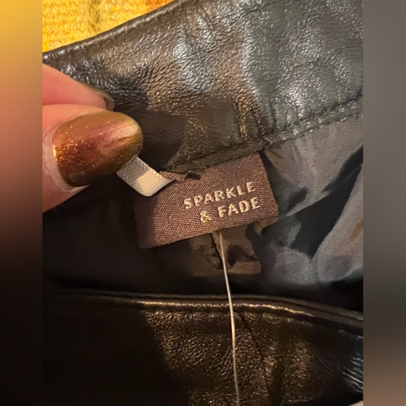 Genuine leather black mini shorts lined with silver metal grommets. Size 8 - Picture 5 of 7